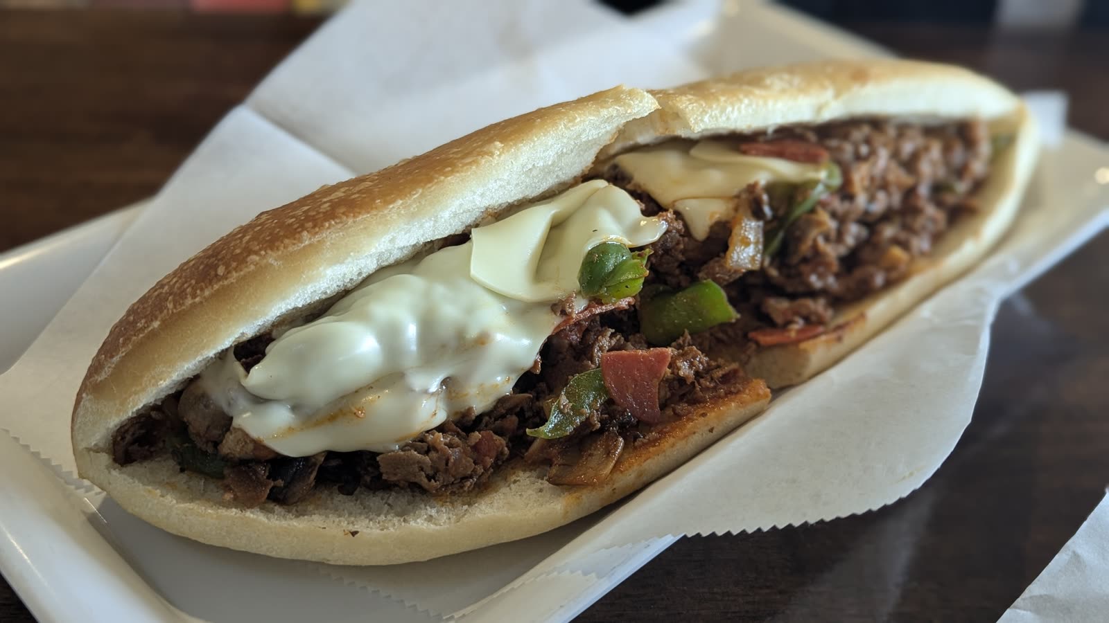 Bruno's cheesesteak with peppers, onions, pepperoni, and melted cheese